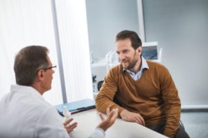Man asking questions of doctor Loria Medical man asking dr questions